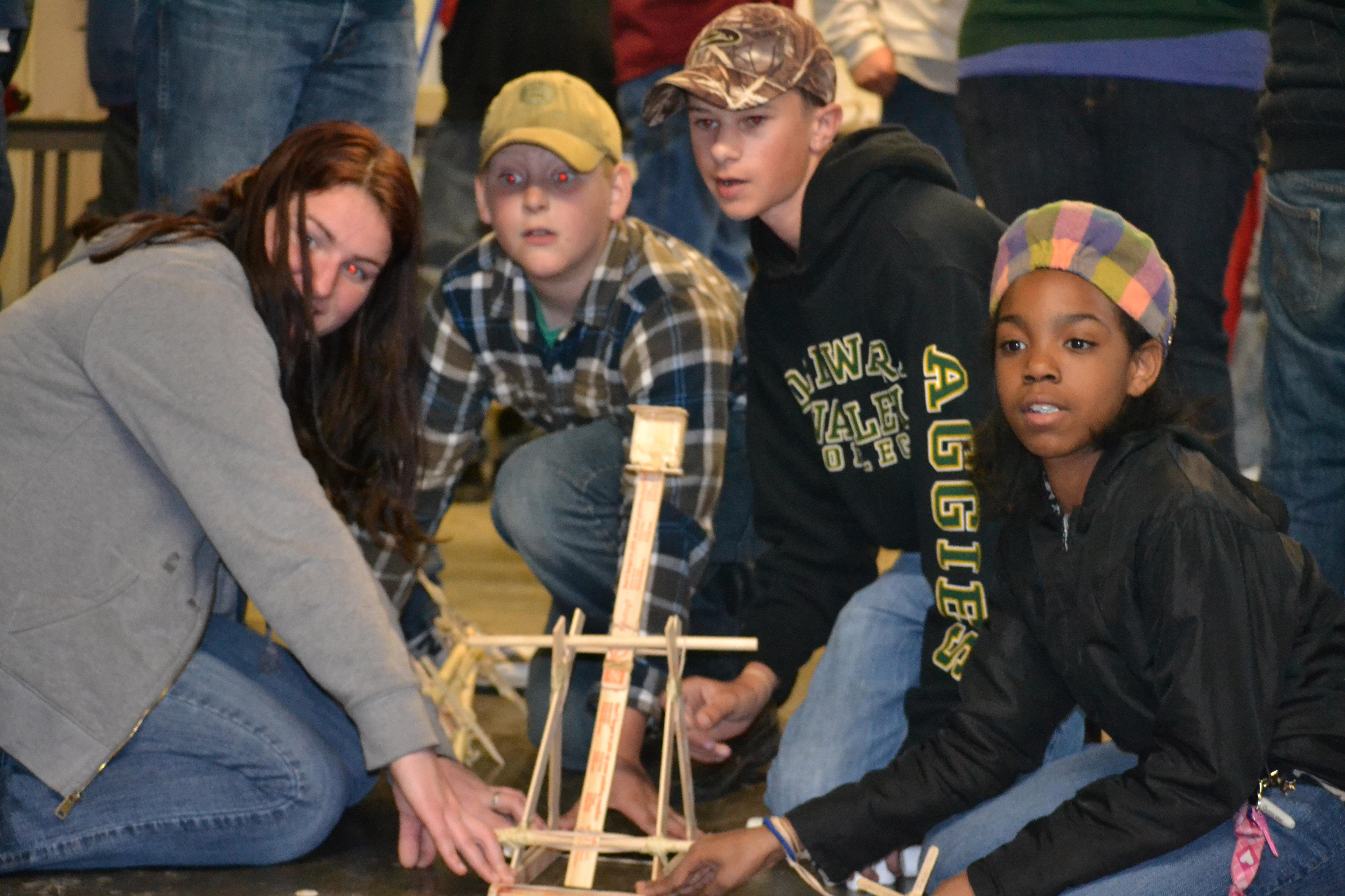 youth shooting a catapult they built