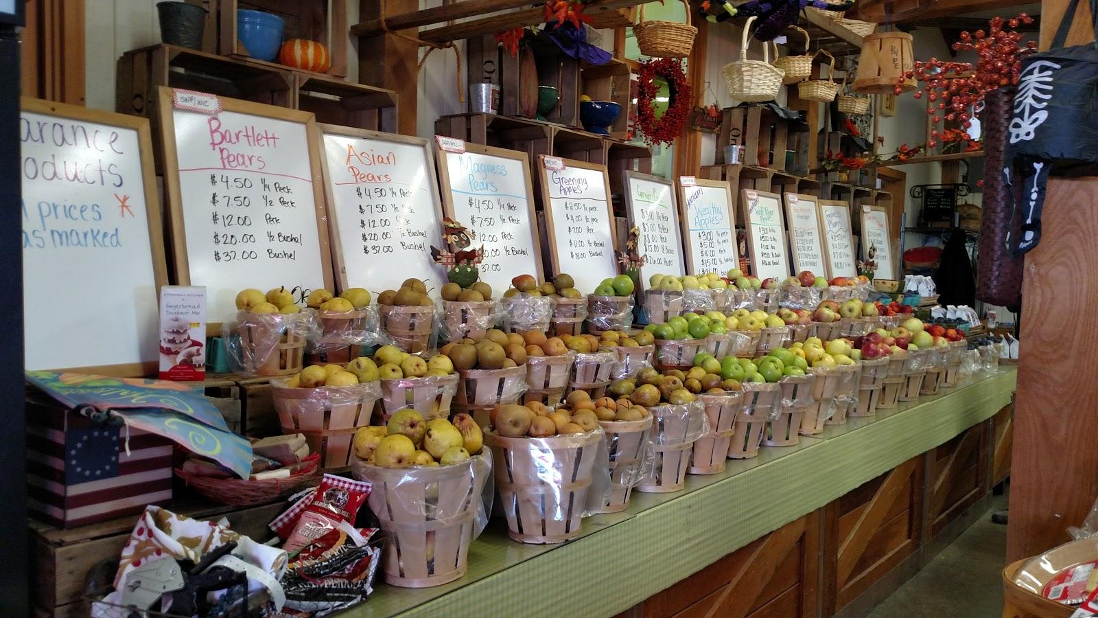 Signage and an attractive display makes it easy for customers to select varieties and see pricing. The neutral colored counter covering accents the color of the fruits.