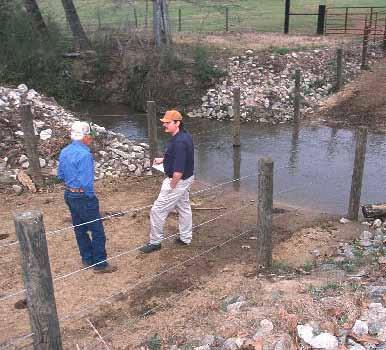 Two men talking between fencing