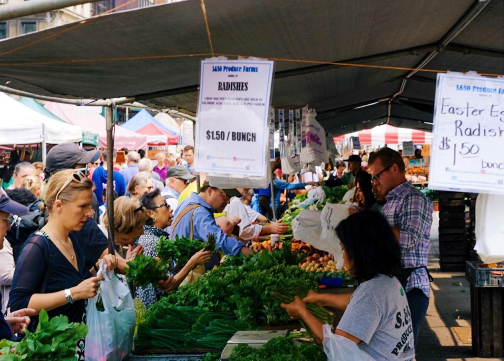 Farmer selling produce at a farmers market