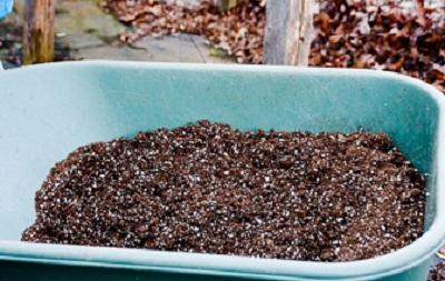 dry seed starting media in a wheelbarrow