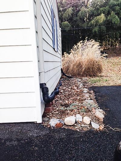 flexible tube draining runoff into yard