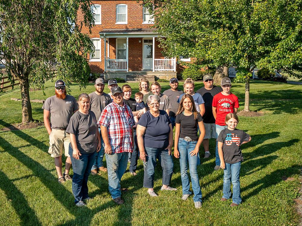 family outside of farm house